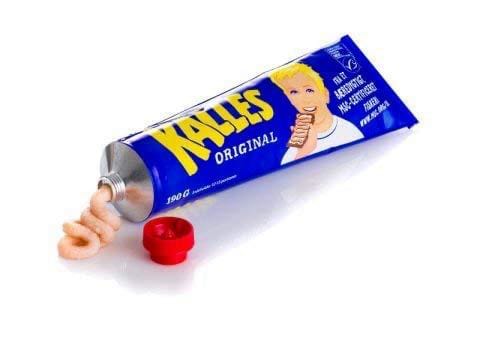 A tube of Kalles Kaviar, a Swedish salty fish-egg spread for sandwiches. The lid is off and some "kaviar" has been pressed out, revealing a pinkish swirly paste.