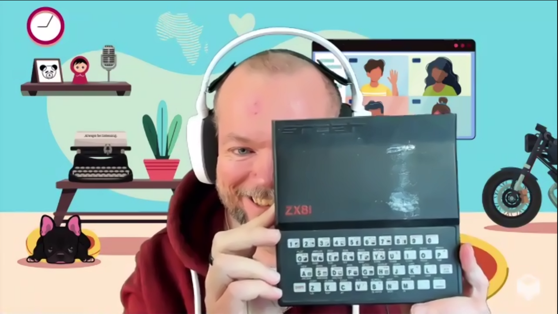 Per proudly holding up his Sinclair ZX81 computer with a big smile.